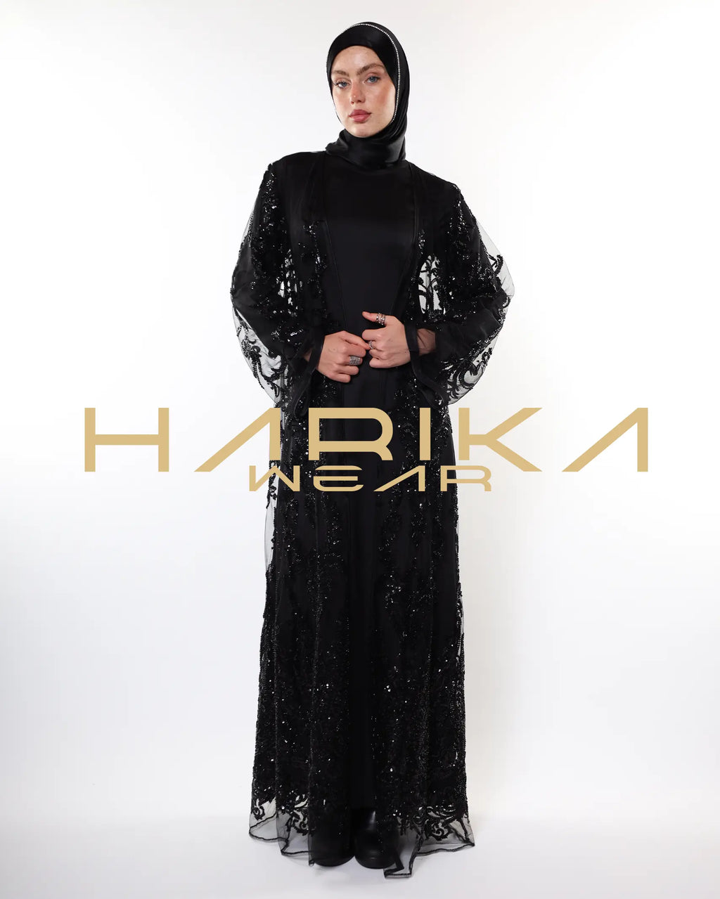 Black abayas designed from tulle fabric embroidered with shiny crystals