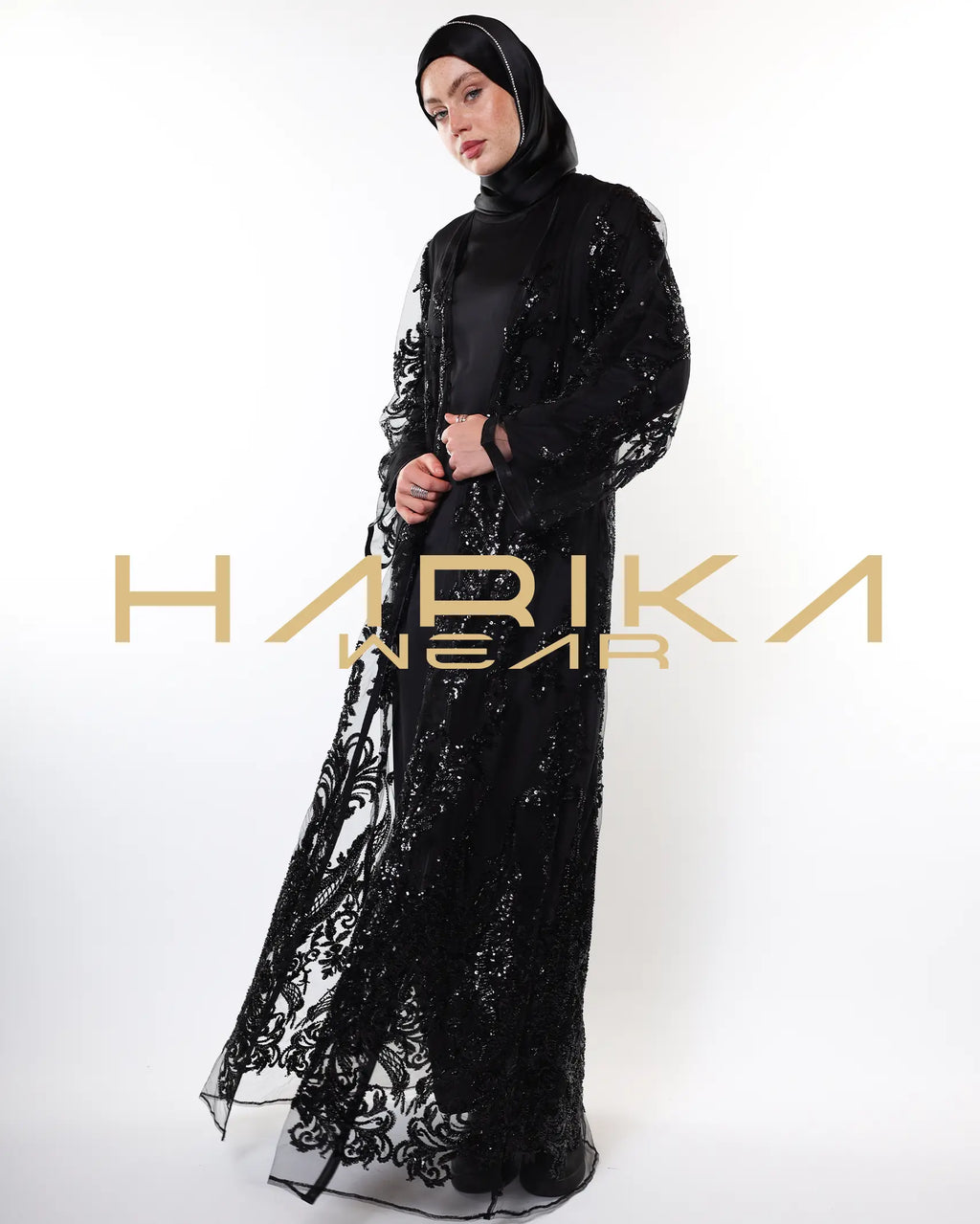Black abayas designed from tulle fabric embroidered with shiny crystals