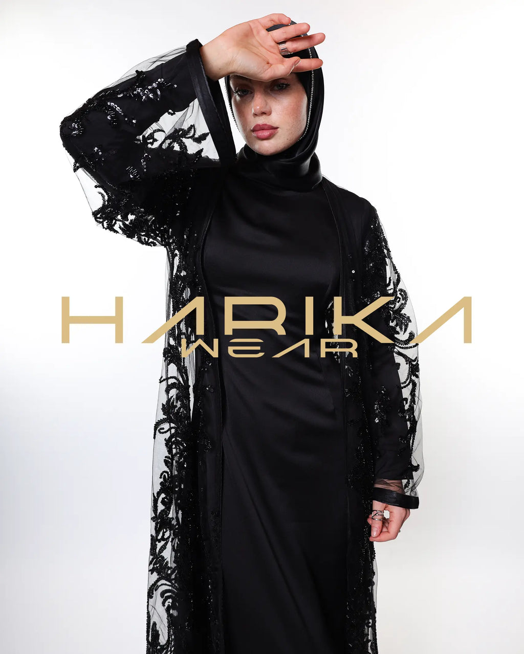 Black abayas designed from tulle fabric embroidered with shiny crystals