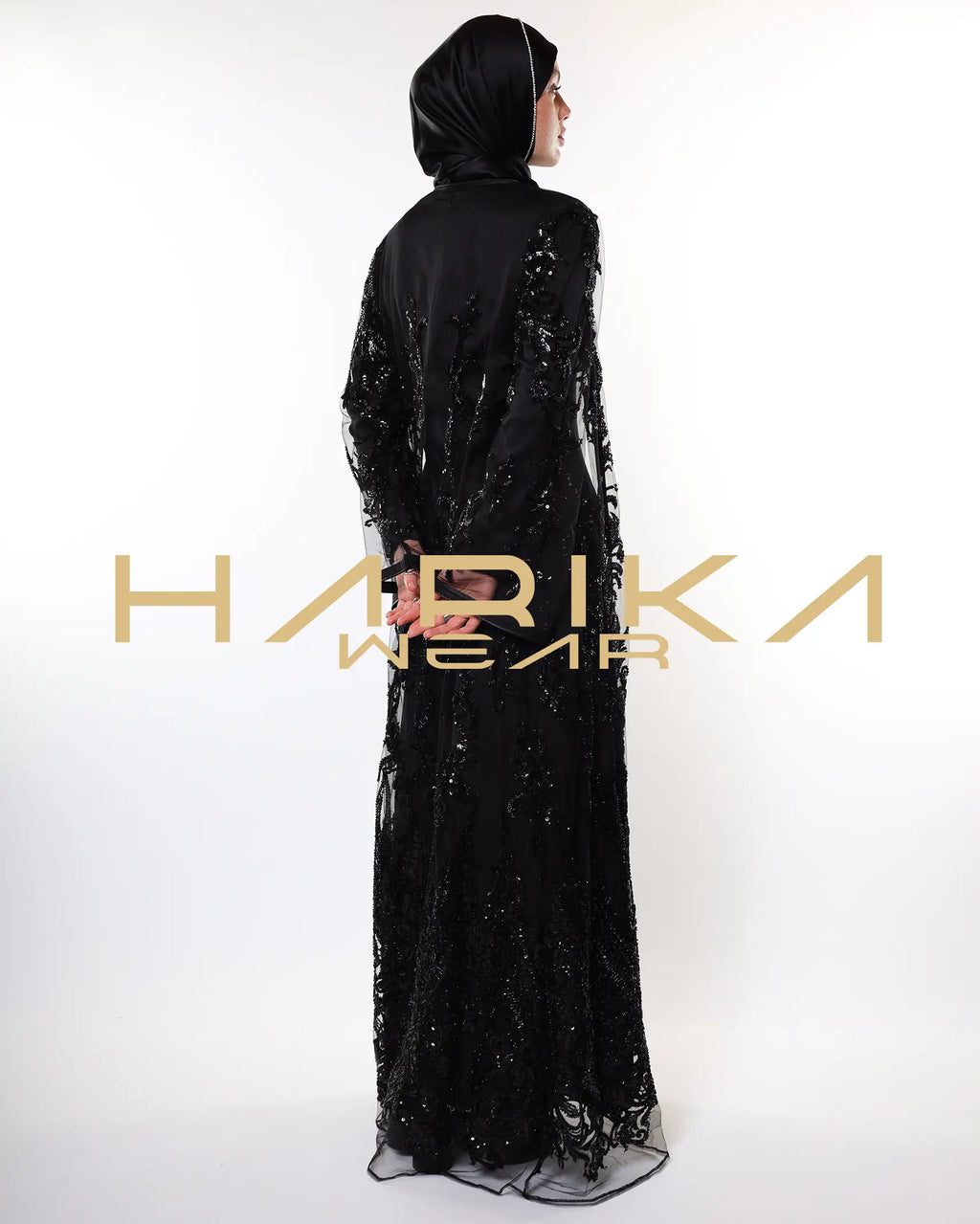 Black abayas designed from tulle fabric embroidered with shiny crystals