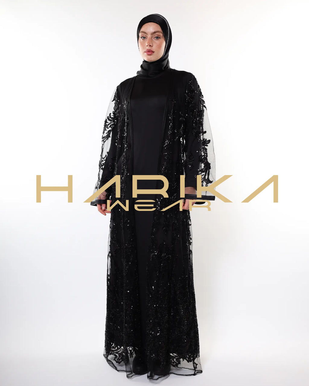 Black abayas designed from tulle fabric embroidered with shiny crystals
