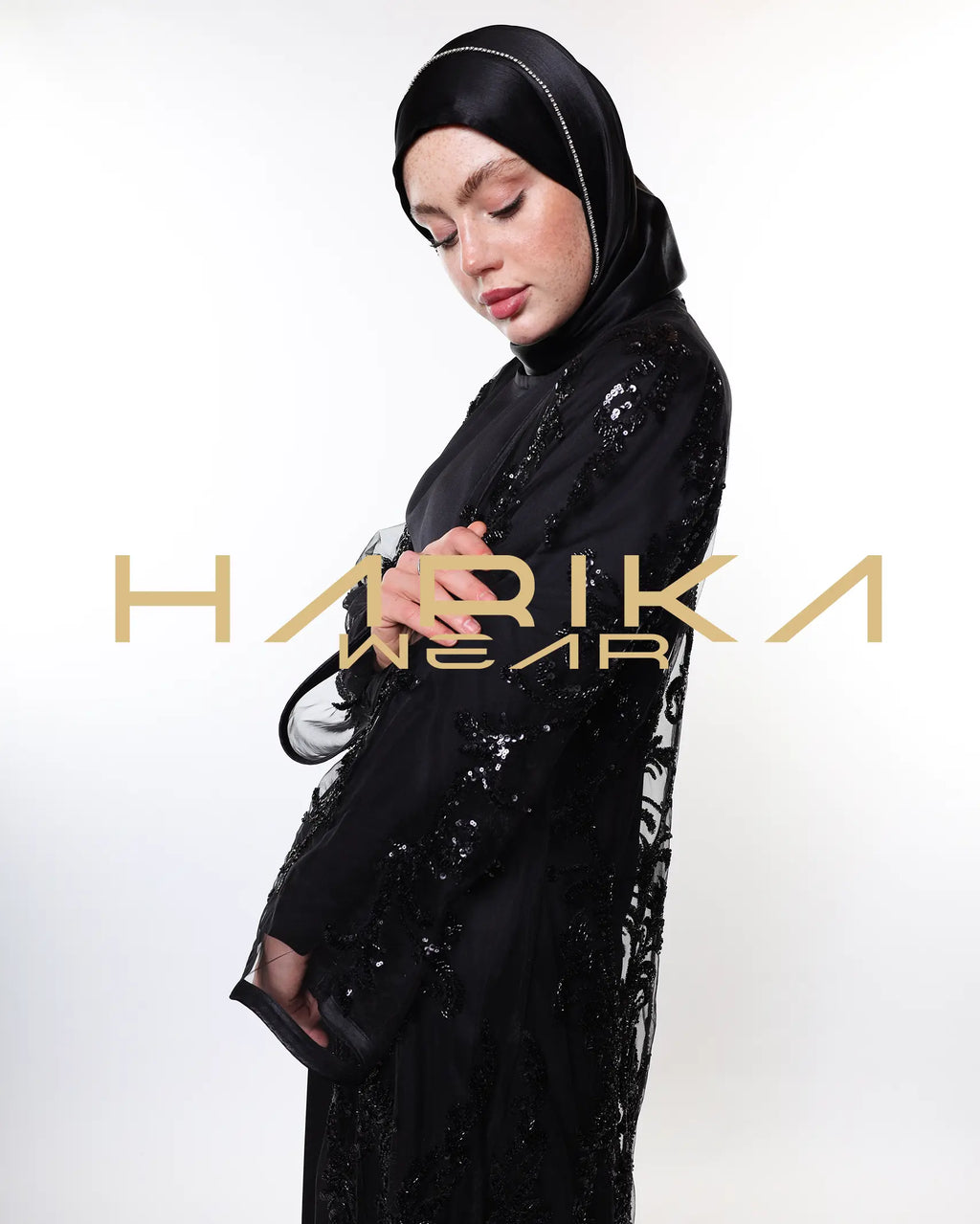 Black abayas designed from tulle fabric embroidered with shiny crystals