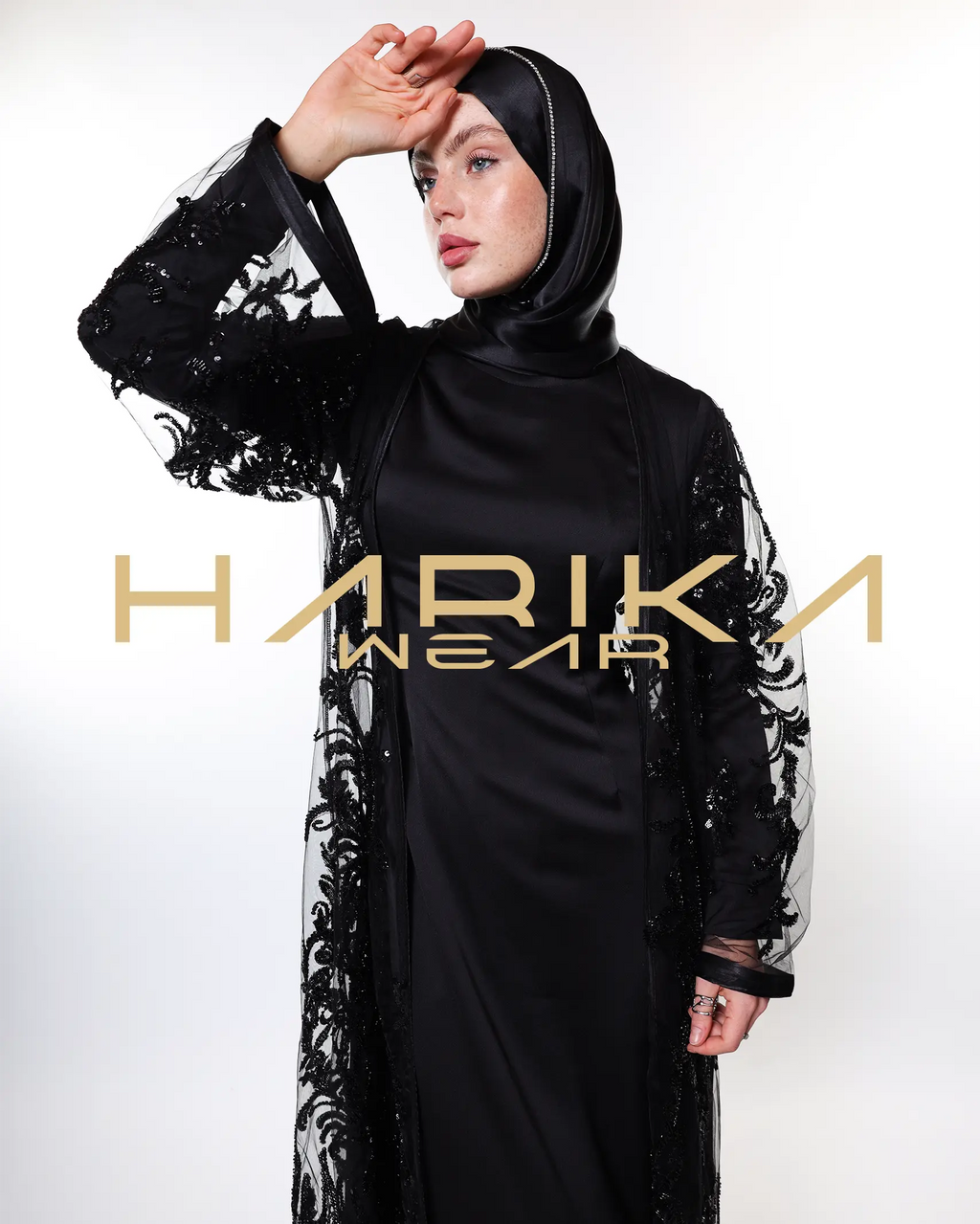 Black abayas designed from tulle fabric embroidered with shiny crystals